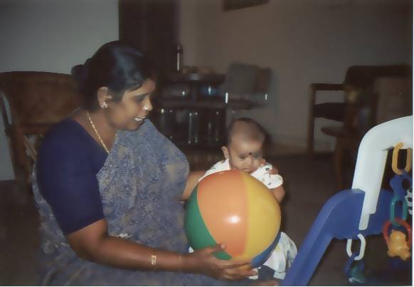 A woman playing with children; Actual size=180 pixels wide